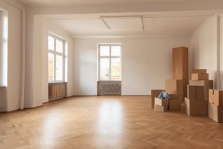 Unfurnished room with many large cardboard boxes. AI generative.